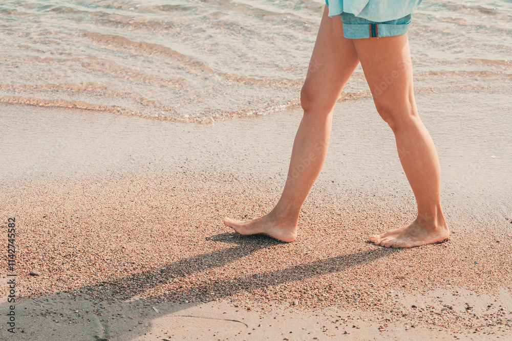 Woman walking barefoot on the beach enjoying summer vacation Woman walking barefoot on the beach enjoying summer vacation