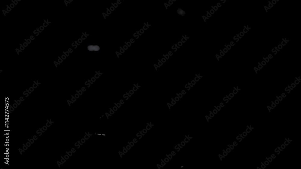 Dust particles overlay floating in the air against black background. Blurred motion of blowing dirt particles. Dust particles overlay floating in the air against black background. Blurred motion of blowing dirt particles.
