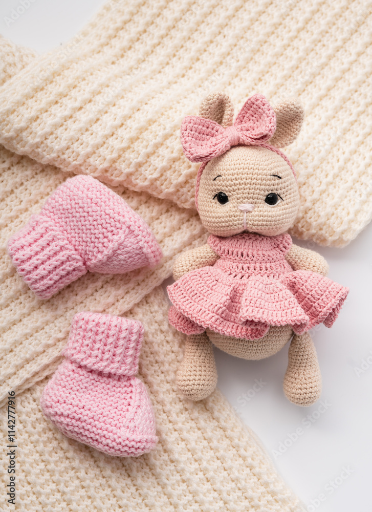 Fototapeta premium Variety of knitted toys. Bunny and baby booties. Handmade soft toys.