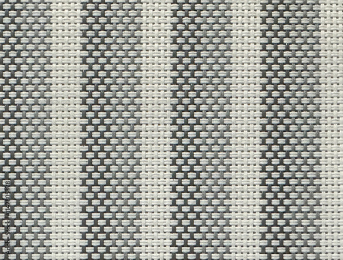 Close up of hand woven synthetic bamboo rattan in grey vertical stripes pattern. Light and dark grey fluted stripes bamboo weaving pattern seamless background texture