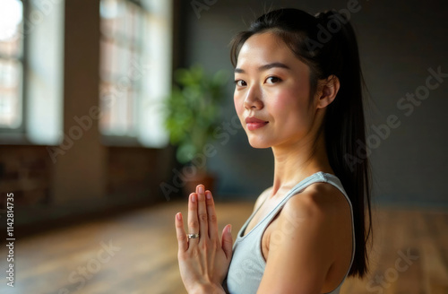 Beautiful Female Yoga Teacher. Portrait of young Asian woman, in the in a Yoga studio, in a loft interior. Beauty and youth, relax and recover down in a calm environment, healthy lifestyle concept