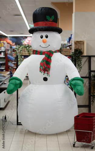 white snowman with a black hat stand foyer small shop .