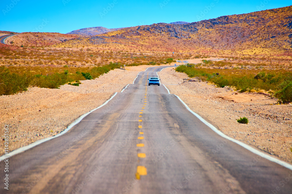 Solitary Car on Desert Road in Moapa Valley Eye Level Perspective Solitary Car on Desert Road in Moapa Valley Eye Level Perspective