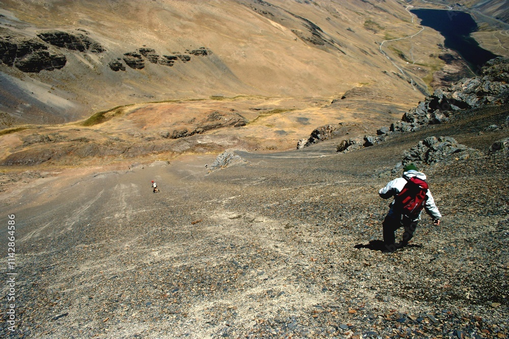 Hikers in Bolivia's Rugged Terrain
Andes mountains under a bright blue sky with scattered clouds in Bolivia. Hikers in Bolivia's Rugged Terrain
Andes mountains under a bright blue sky with scattered clouds in Bolivia.