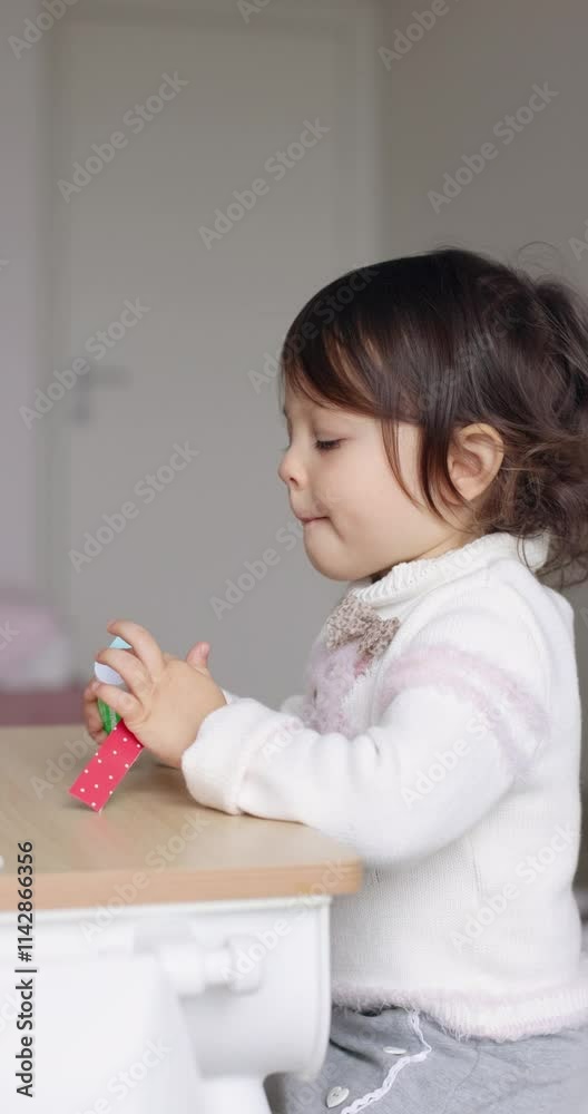 cute little child girl gluing paper garlands and preparing for Christmas . Christmas concept, kids development cute little child girl gluing paper garlands and preparing for Christmas . Christmas concept, kids development