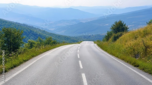 long, empty mountain road stretching towards the horizon on a summer day, partially shrouded in a mystical light mist, inviting viewers to imagine adventures ahead