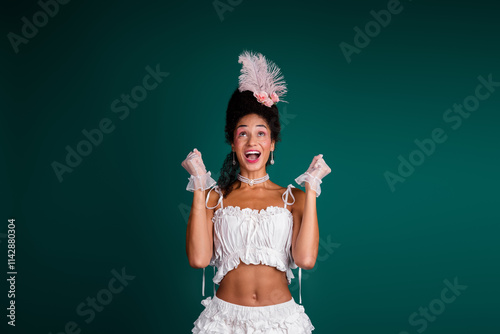 Young woman in elegant antique costume against a vibrant green background