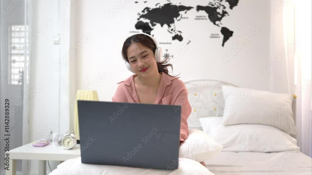 Asian young woman relaxing before bedtime on the bed in the bedroom Asian young woman relaxing before bedtime on the bed in the bedroom