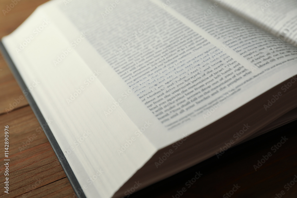 Open Holy Bible in English language on wooden table, closeup Open Holy Bible in English language on wooden table, closeup