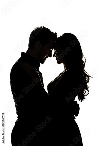 Romantic silhouette of a couple embracing in the dark.