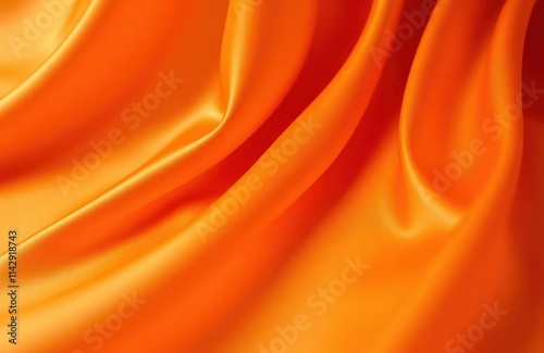 Closeup view of orange fabric. Smooth, shiny texture with flowing drapes. Material luxurious, elegant. Looks like satin silk. Bright orange colour. Soft, tender appearance. Design abstract, photo