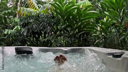 Wallpaper Mural Woman's feet immersed in a hydromassage surrounded by nature, slow motion Torontodigital.ca