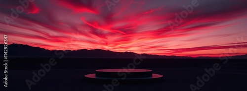 Dramatic sunset scene in dark desert landscape. Sleek black podium prominently featured. Stunning gradient colors in sky. Ideal for product. Evokes sense of elegance, modernity. Backdrop work well photo