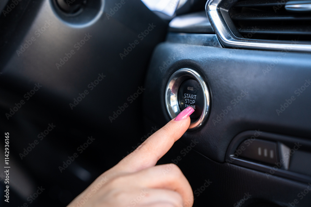 The female driver is trying to start the car's engine. The female driver is trying to start the car's engine.
