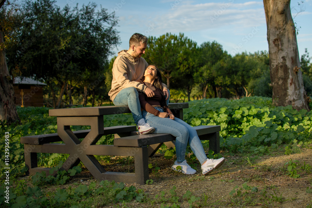 young couple in love chatting on park bench young couple in love chatting on park bench