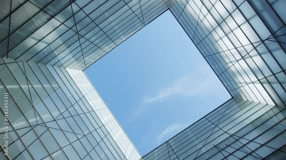 A Beautiful Modern Architectural Perspective Viewed from Below Against a Clear Blue Sky A Beautiful Modern Architectural Perspective Viewed from Below Against a Clear Blue Sky