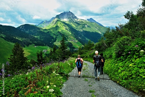 Austrian Alps - view of Biberkopf mountain and tourists on the road near the path of Warth in the Lechtal Alps photo