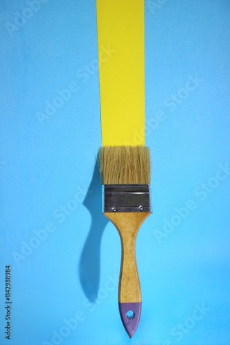 Fototapeta Naklejka Na Ścianę i Meble -  creatively arranged paint brushed on a blue background with yellow lines