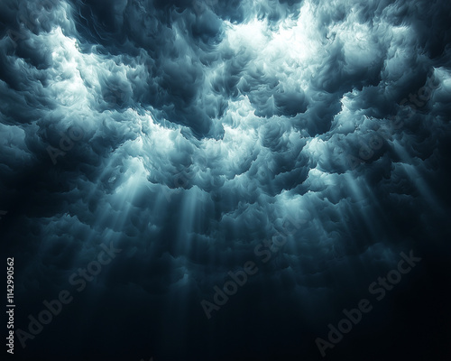 deep ocean storm, dense blue clouds and shafts of light penetrating the watery abyss photo