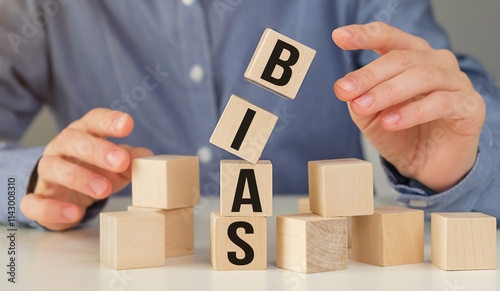 Bias text on wooden cubes on table with young woman's close-up hands background photo