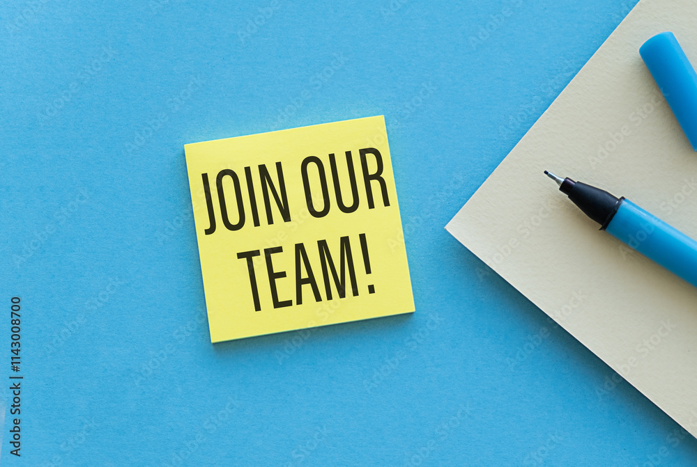 A yellow sticky note with the words Join Our Team written on it is sitting on a A yellow sticky note with the words Join Our Team written on it is sitting on a