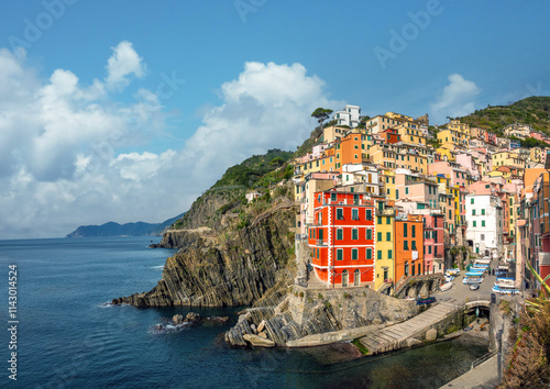 The photogenic fishing harbor and sea front of the village of Riomaggiore, Cinqueterre, La Spezia, Liguria, Italy photo