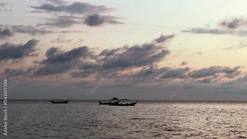 Sailing boats floating in sea ocean at sunset under dramatic sky. Traditional water transport for local work, job. Fishing industry. Peaceful nature background with boats on sea water Sailing boats floating in sea ocean at sunset under dramatic sky. Traditional water transport for local work, job. Fishing industry. Peaceful nature background with boats on sea water