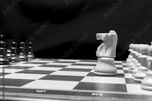 Chessmen photographed on a chessboard with a dark background