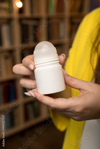 Eco-friendly deodorant stick in a sleek design held by a woman. A symbol of natural beauty and sustainable self-care.