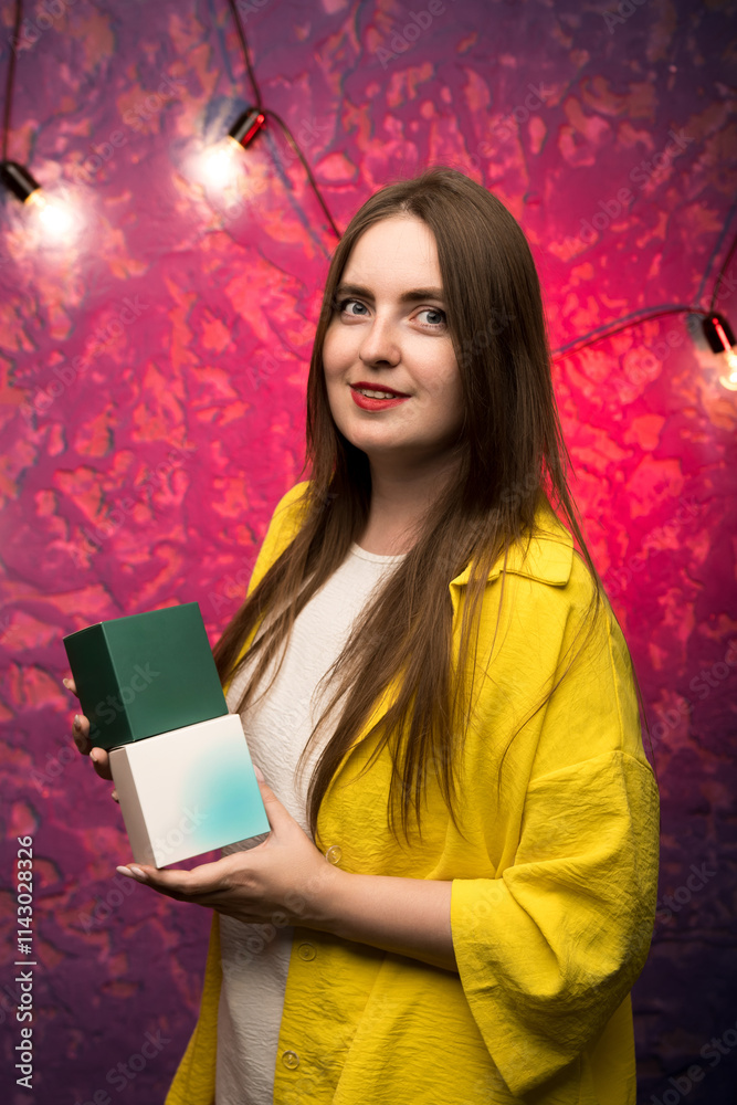 A woman in yellow showcasing sleek, colorful boxes with gradient designs. Perfect for branding and e-commerce. A woman in yellow showcasing sleek, colorful boxes with gradient designs. Perfect for branding and e-commerce.