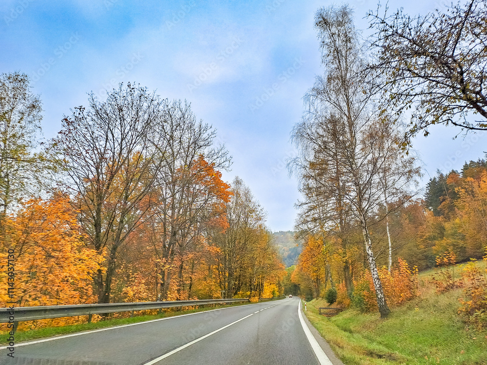road in autumn with autumn trees. Mountain road near Harrachov, Czech road in autumn with autumn trees. Mountain road near Harrachov, Czech
