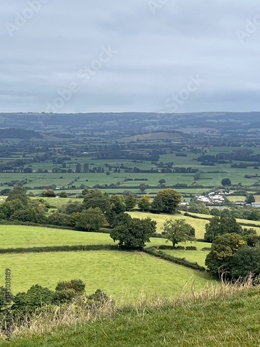 View from the top of Glastonbury torr in Somerset overlooking the fields of Glastonbury festival on a cloudy autumn day in England  photo