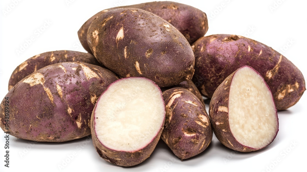 A pile of purple potatoes with a slice cut in half A pile of purple potatoes with a slice cut in half