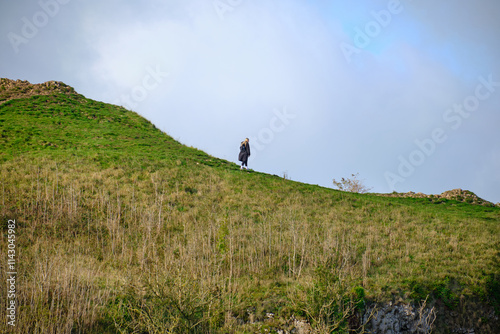 Solitary figure standing on a cliff edge photo