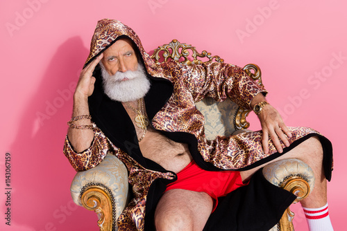 Photo of serious extravagant man wear leopard coat hood sit throne isolated on pink color background