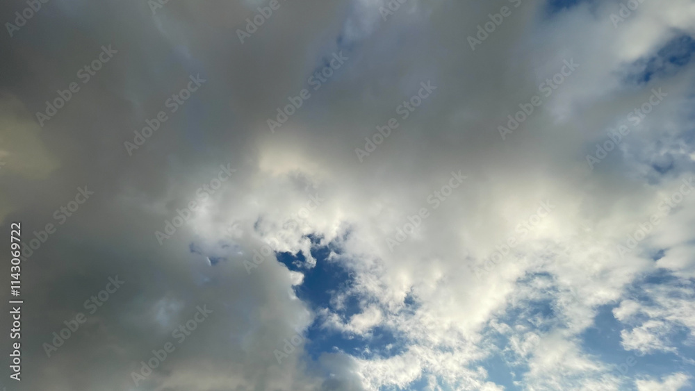 Bright blue sky with fluffy white clouds scattered across the horizon, creating a calm and serene atmosphere perfect for backgrounds and nature-themed visuals. Bright blue sky with fluffy white clouds scattered across the horizon, creating a calm and serene atmosphere perfect for backgrounds and nature-themed visuals.