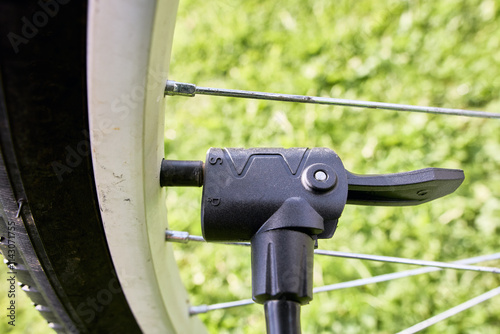 Attaching dual head nozzle adapter of air pump to bicycle valve.