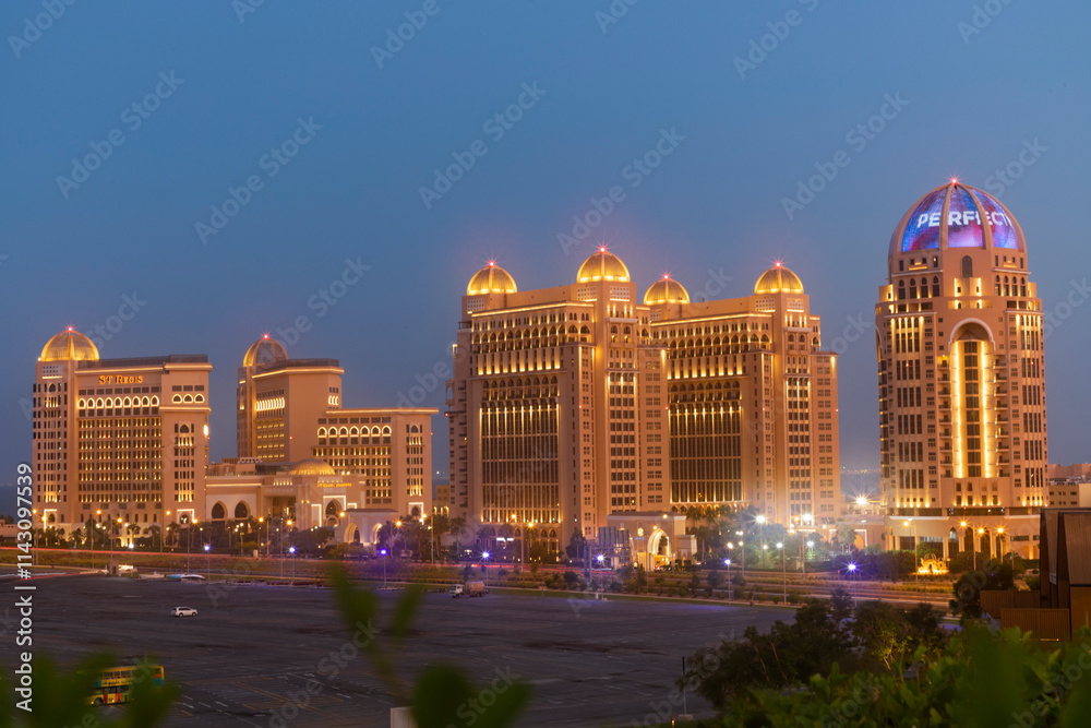 Naklejka premium Doha, Qatar October ‎9, ‎2024: A view of Katara Park and Doha Towers with beautiful colors of the sky