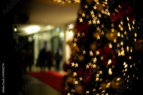 Star formed lights bokeh and people in a shopping center