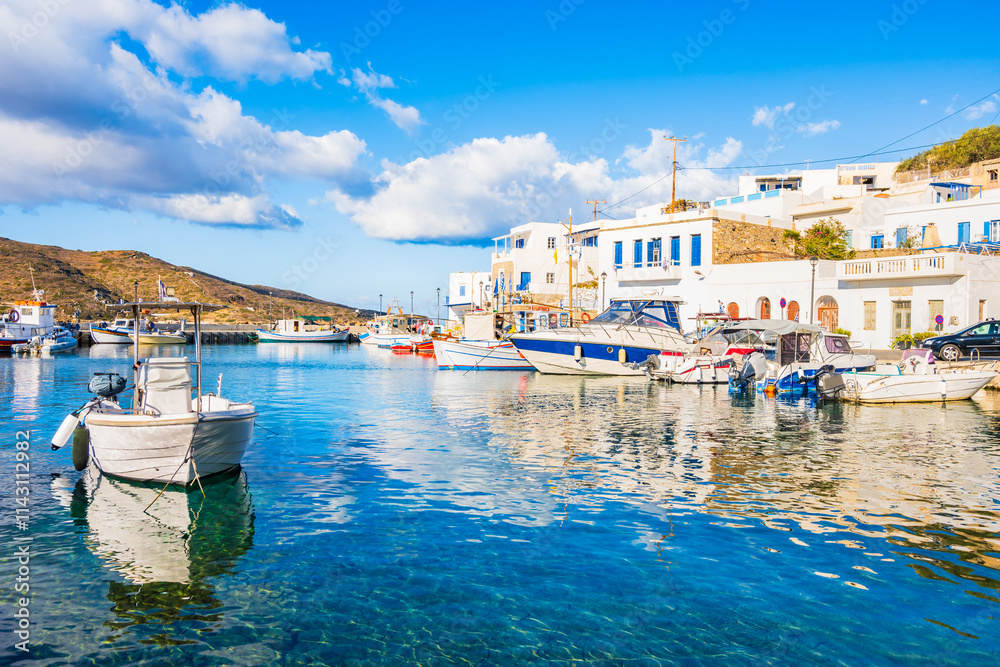 Boats anchoring in Katapola port with white houses on shore, Amorgos island, Cyclades, Greece