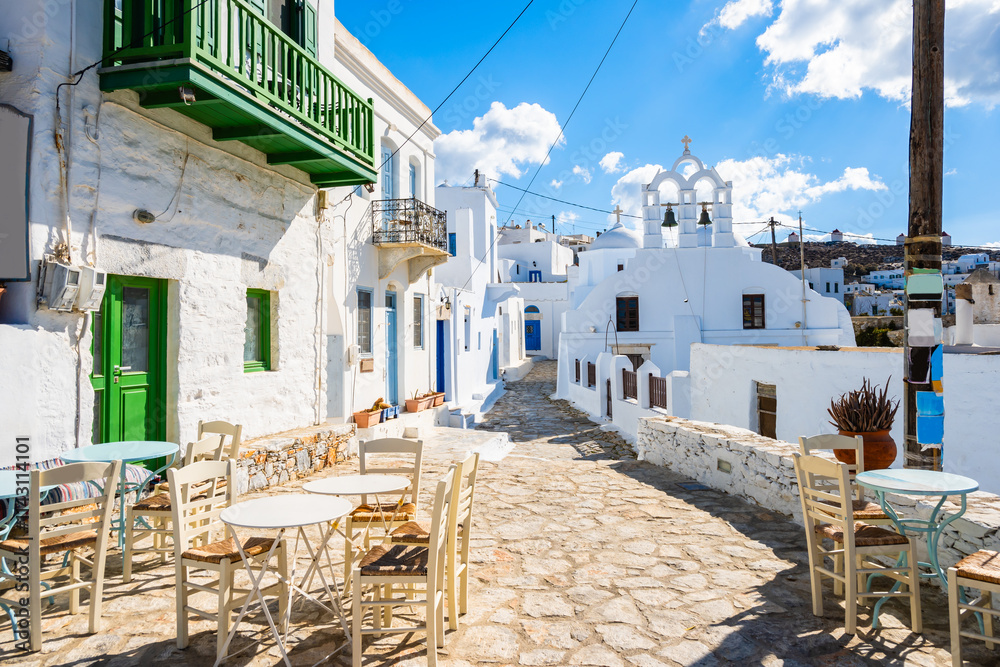 White church in narrow street of historic old part of Chora village, Amorgos island, Cyclades, Greece