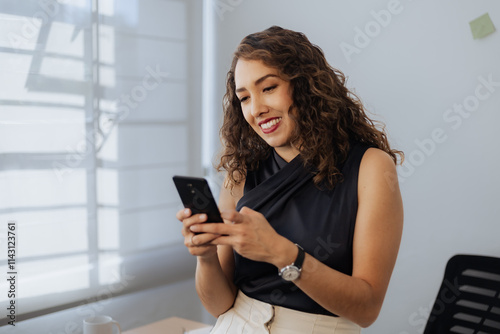 Mexican woman using phone in office