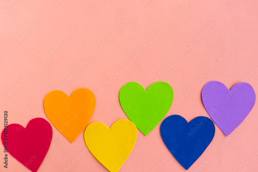Hearts in lgbtq colors on pastel pink background, top view, copy space Hearts in lgbtq colors on pastel pink background, top view, copy space