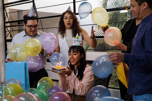 Mexican coworkers celebrating birthday in office