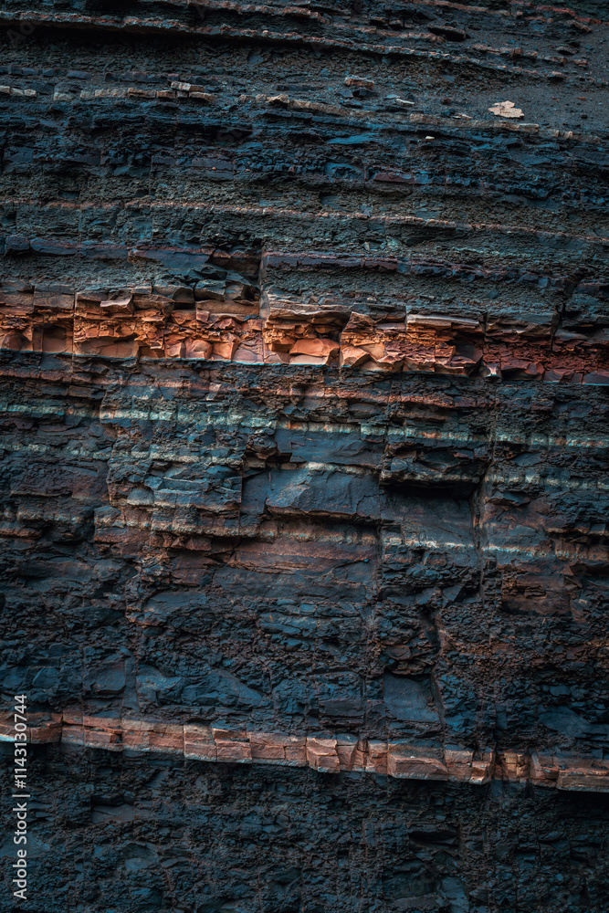 Close-up of layered basalt lava and red clay strata near Hengifoss waterfall, showcasing Iceland's volcanic history. Close-up of layered basalt lava and red clay strata near Hengifoss waterfall, showcasing Iceland's volcanic history.