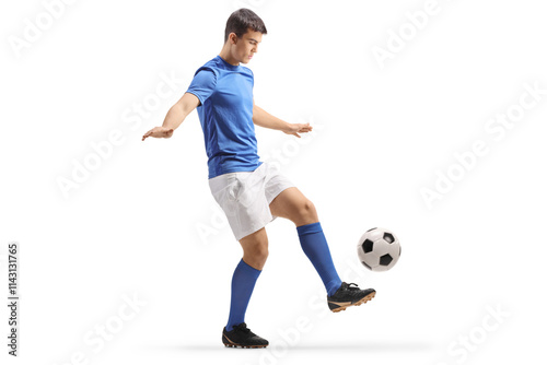 Football player in a blue top and white shorts kicking a ball