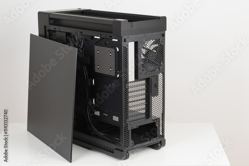 Side view of empty  big tower, PC case, chasis, without upper , left metal panel  and  tempered-glass right  panel. At the bottom is a cover for power supply unit