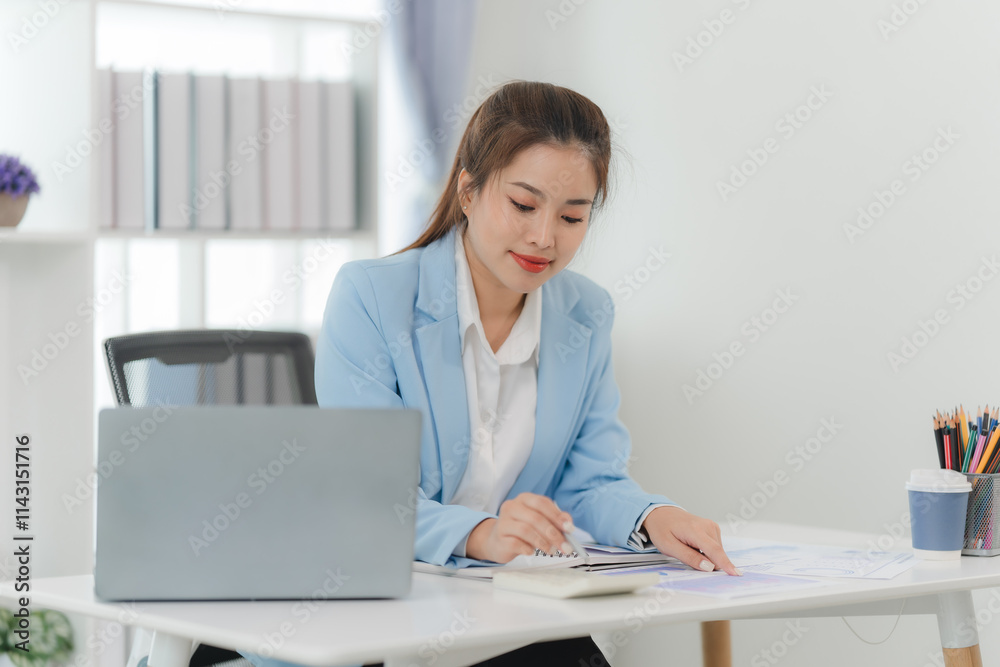 Focused Businesswoman Analyzing Data: A portrait of a concentrated businesswoman reviewing financial documents at her modern desk, showcasing dedication and professionalism. Focused Businesswoman Analyzing Data: A portrait of a concentrated businesswoman reviewing financial documents at her modern desk, showcasing dedication and professionalism.