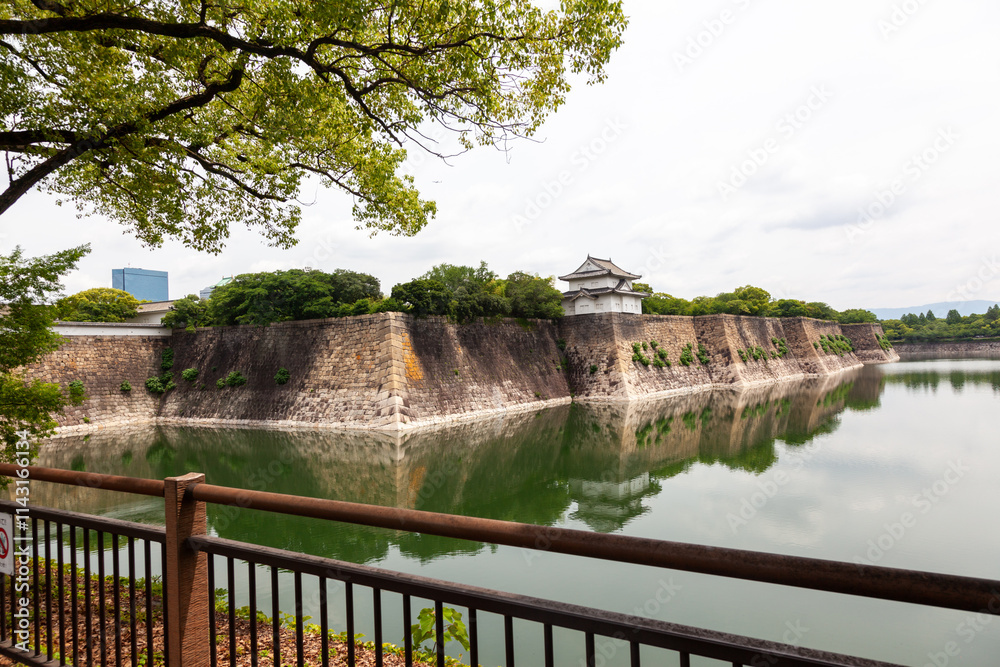 Historic Japanese Castle Moat with Reflections and Stone Walls Historic Japanese Castle Moat with Reflections and Stone Walls