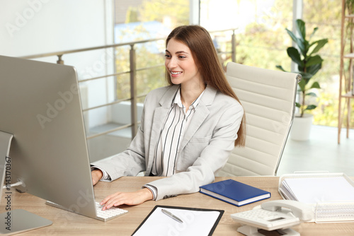 Banker working on computer at table in office